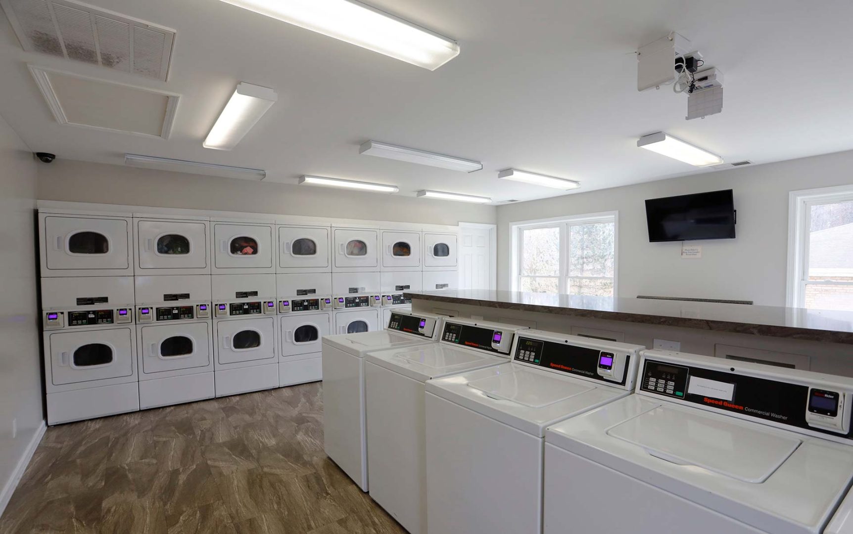 a laundry room with washers and dryers at The Pine Hills