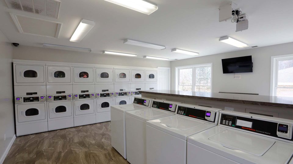 a laundry room with washers and dryers at The Pine Hills