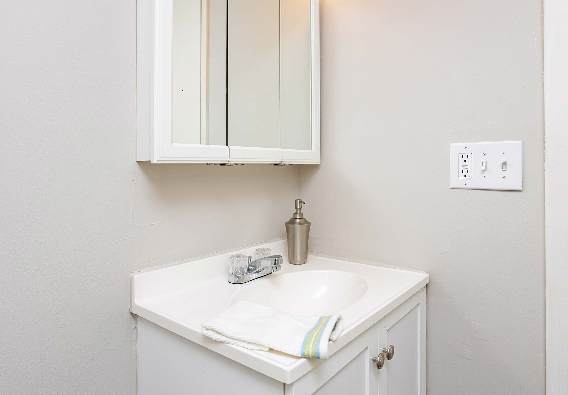 a bathroom with a white sink and cabinet at The Pine Hills