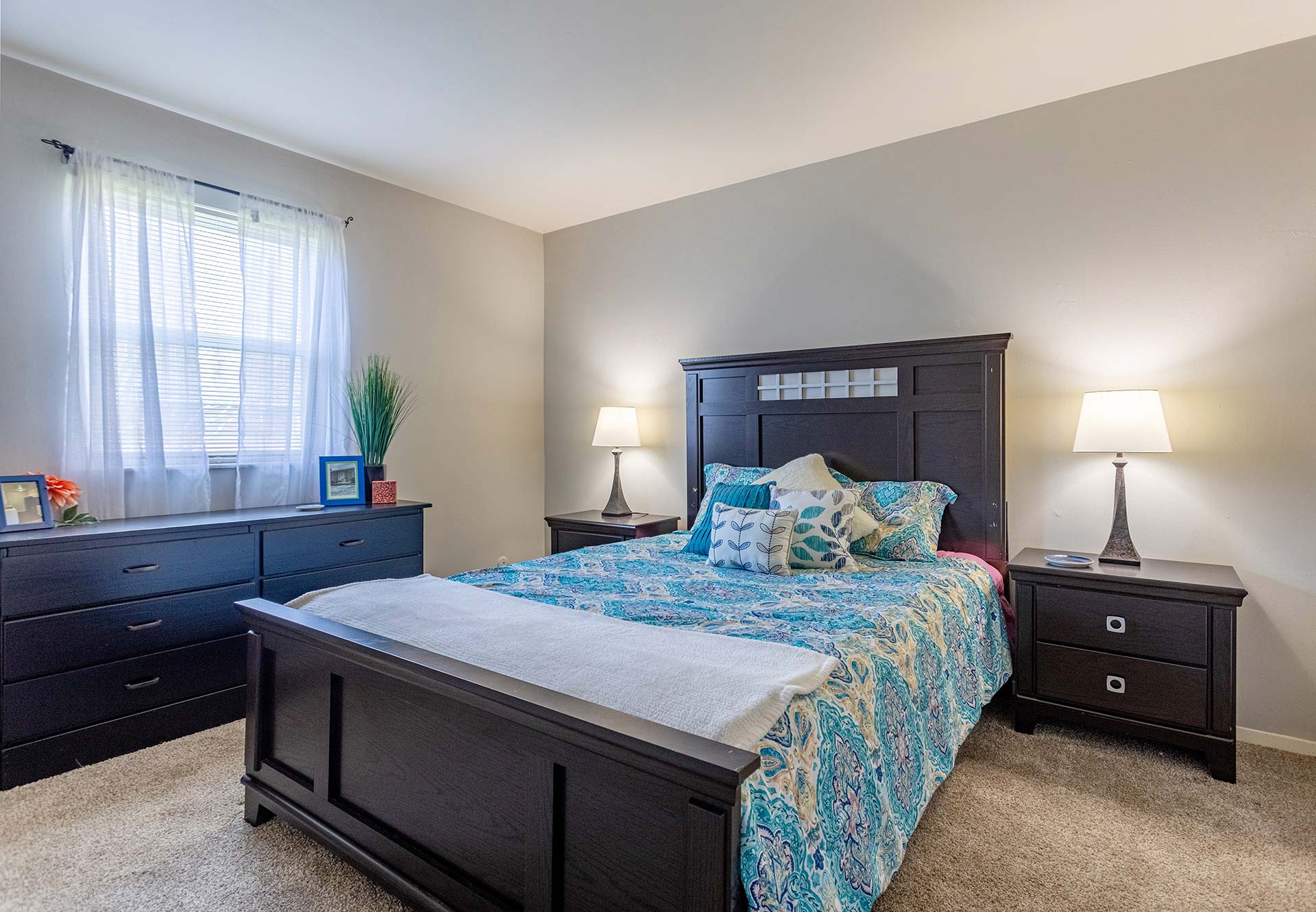 a bedroom with a bed, dresser and nightstand at The Pine Hills